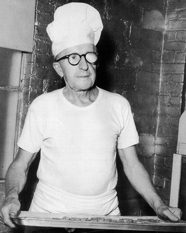 Black and white photo of Charles "Pop" Birnn wearing glasses and a white confectioner's hat.